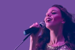 singer in sequin dress purple background