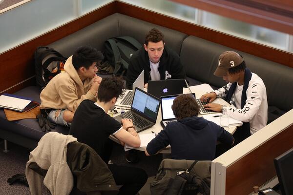 Five students working at laptops in Stauffer Library.
