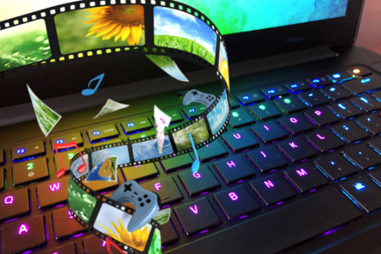 Lap top and digital imagery of film, music, and games